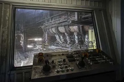 Joystick control panel before a window overlooking the blast furnace.