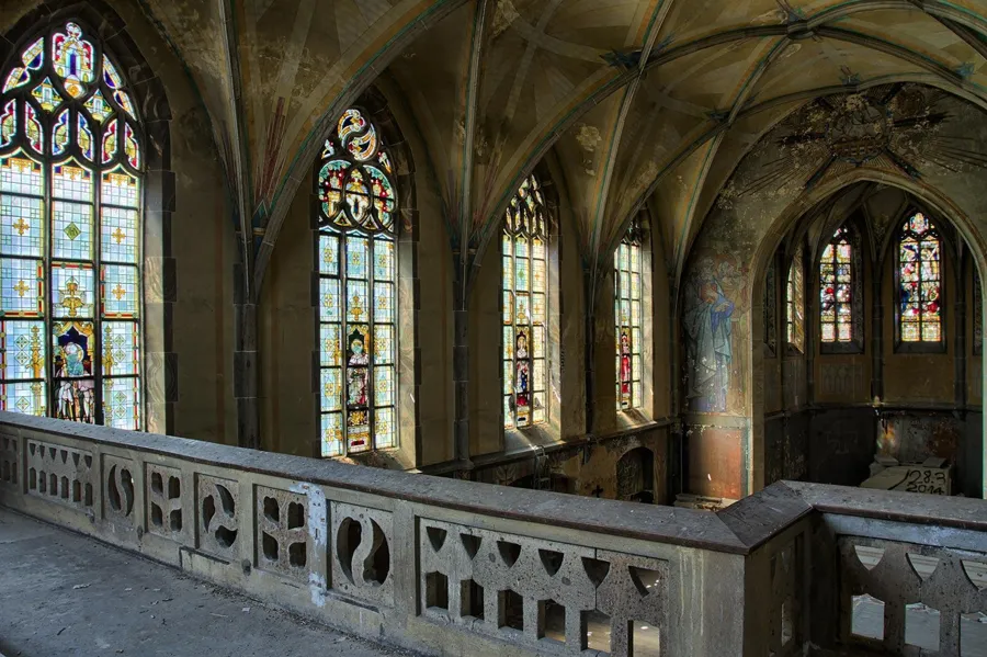 Balustrade de pierre le long des vitraux de la chapelle