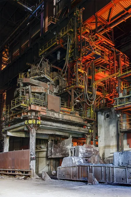 Red pipes and tall steel platforms above heavy installations.