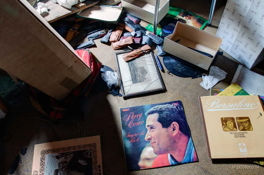 Record sleeves, boxes and scattered belongings on the floor.