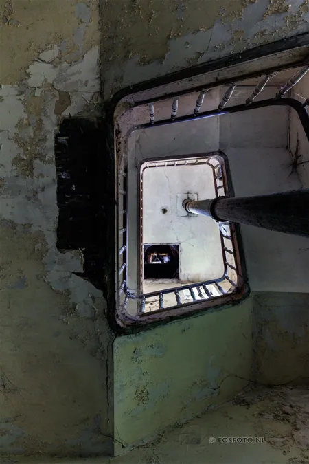 Small mirror on a damaged green wall