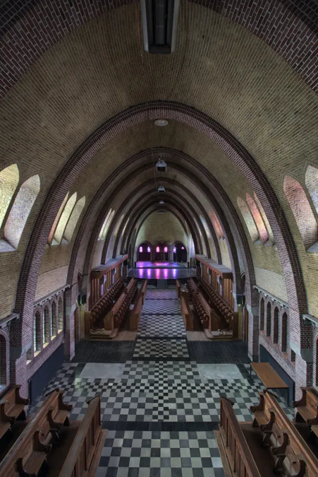 Vista desde balcón elevado sobre capilla y sillería de madera.