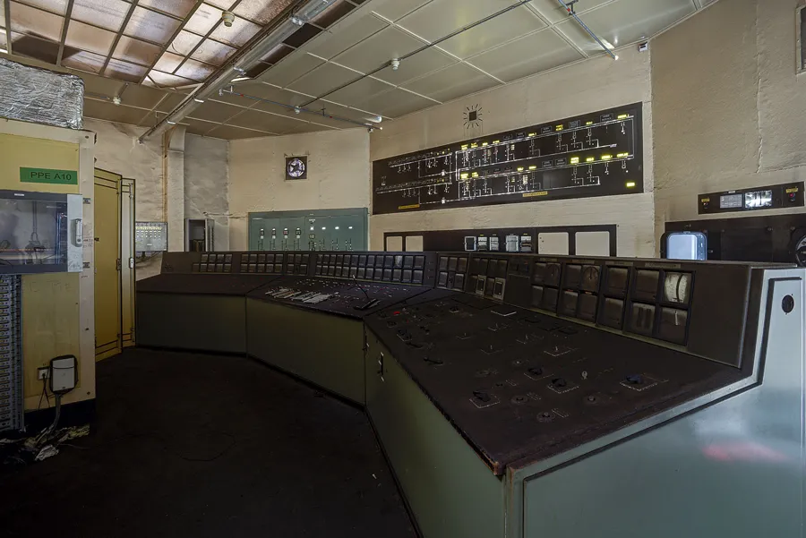 Angle de la salle de commande aux schémas au-dessus des consoles.