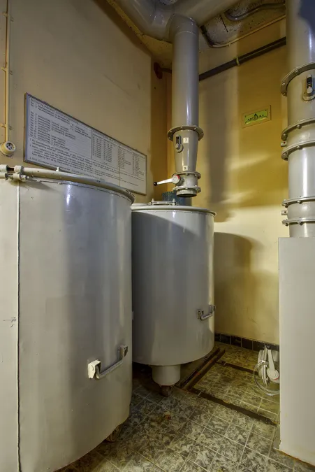 Grote grijze metalen filterkasten aangesloten op verticale leidingen.