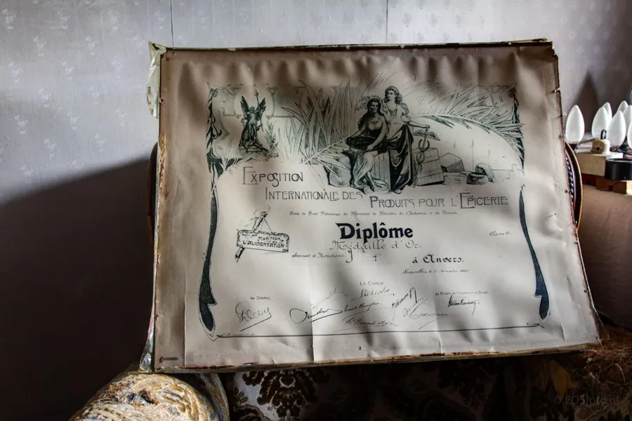 Weathered framed diploma on a chair.