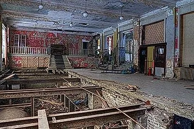 Large hotel hall with a torn-open floor and a raised rear section.