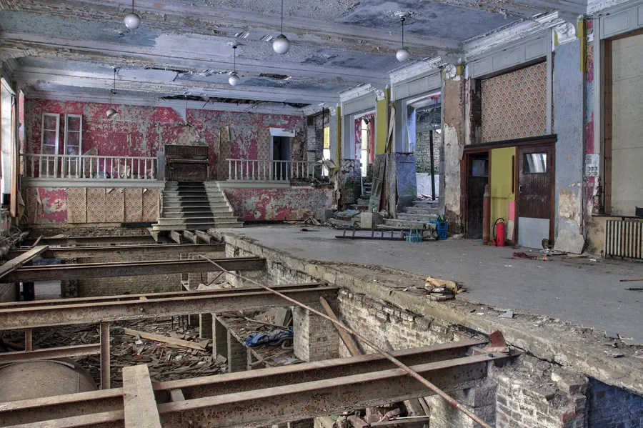 Large hotel hall with a torn-open floor and a raised rear section.