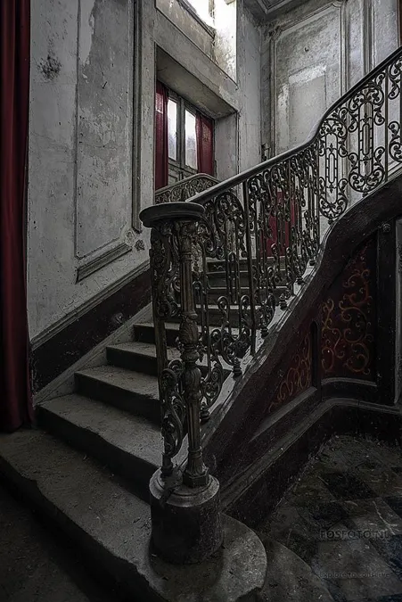 Stone staircase with ornate metal railings
