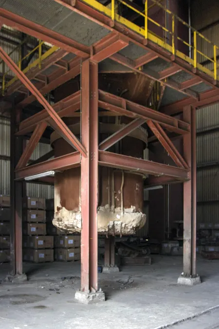 Large suspended vessel between red steel support beams.