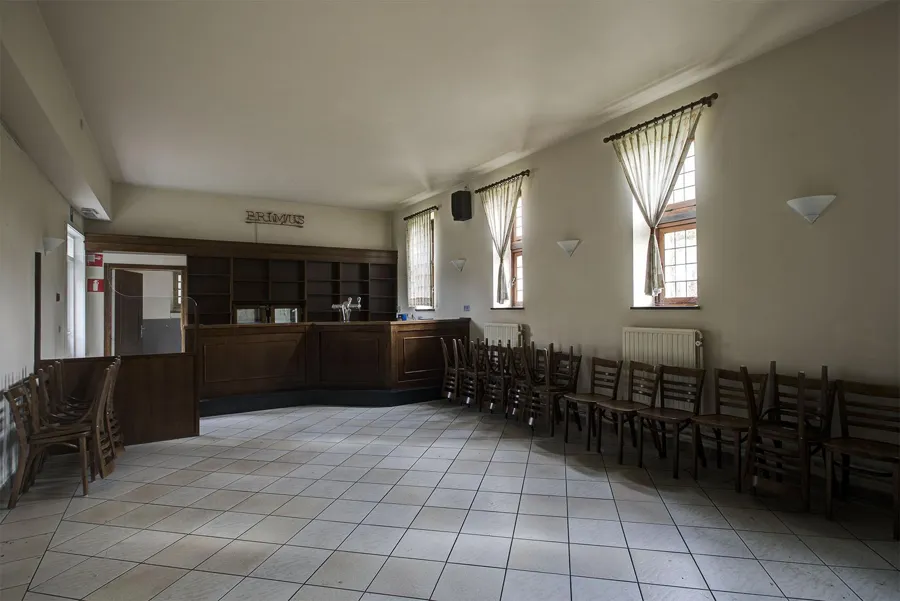 Sala con barra y sillas apiladas junto a la pared