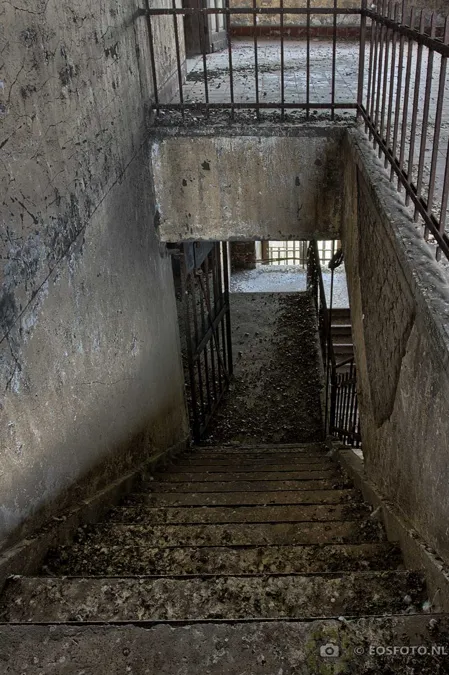 Steep stone stairs descending between weathered walls.