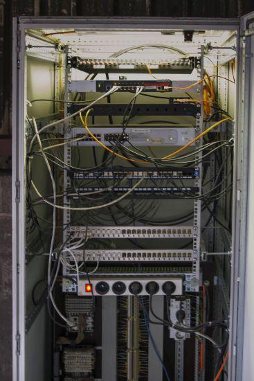 Open electrical cabinet with cables and components